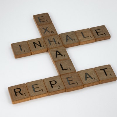 Photo credit to Brett Jordan via Unsplash - photo of game tiles spelling out inhale, exhale, repeat on a page describing relaxation strategies you can learn with Barbara Fordyce & Associates
